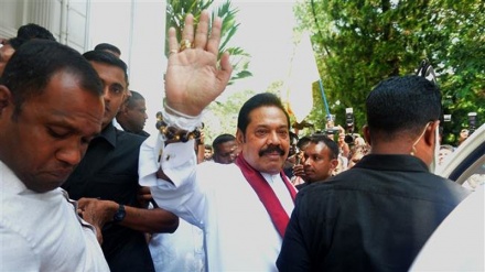 Sri Lanka’s new premier resigns to end deadlock 