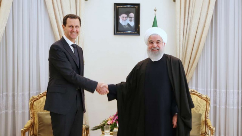 Presiden RII Hassan Rouhani (kanan) dan Presiden Suriah Bashar al-Assad.