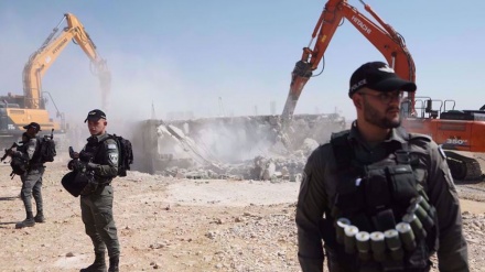 Israeli forces demolish two Palestinian-owned houses in al-Quds, orders owners to pay heavy fines