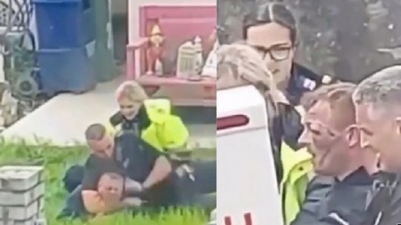 英国北威尔士警察将一男子按在地上勒住脖子并拳头猛击