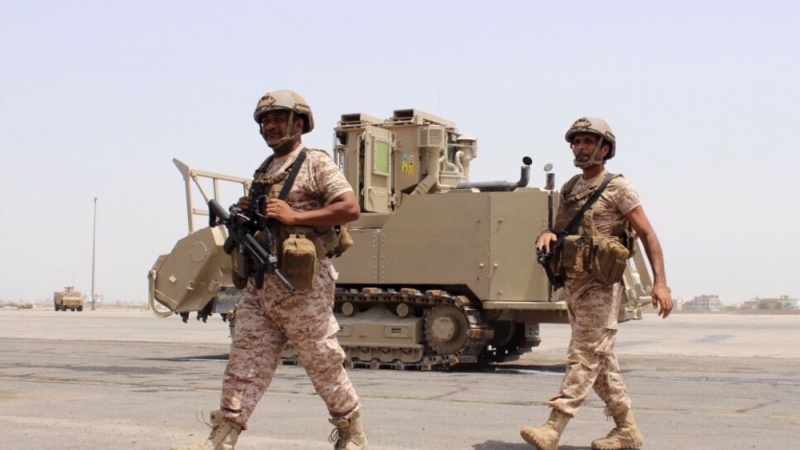 Emirati soldiers walk past a military vehicle at the airport of Yemen\'s southern port city of Aden, on August 12, 2015.