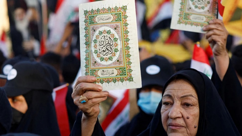 An Iraqi demonstrator holds the Qur\'an during a protest in Baghdad against the burning of a copy of the holy book in Europe, July 22, 2023.
