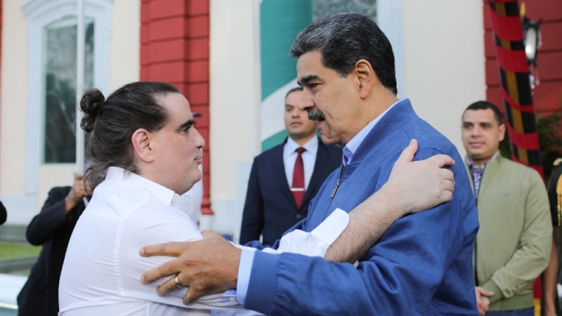 Alex Saab (L) and Venezuelan President Nicolas Maduro embrace following Saab’s release from a US prison and arrival in Venezuela, December 20, 2023.