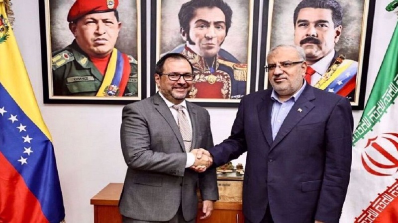 Iranian Oil Minister Javad Owji (R) shakes hands with Venezuela’s Foreign Minister Yvan Gil in Caracas on February 3, 2024.